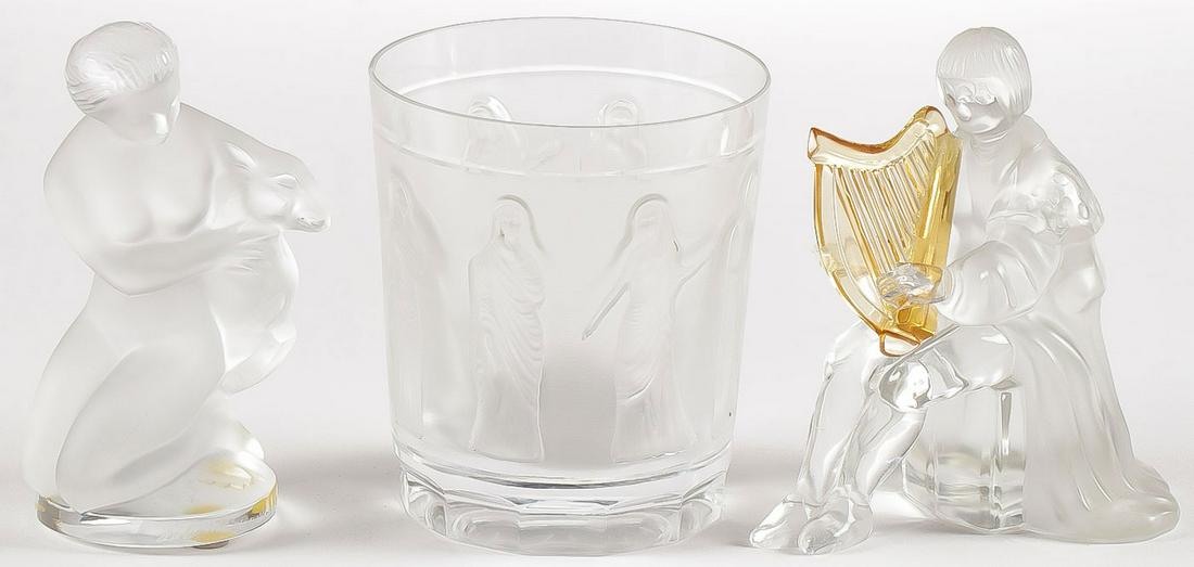 FRENCH FROSTED GLASS GROUP: FRENCH FROSTED GLASS GROUP. Comprising a Lalique kneeling nude with fawn, a Lalique tumbler, and a St. Louis harp player. Greatest height 4.5 inches. SHIPPING NOTICE: Jackson's is your sole and on