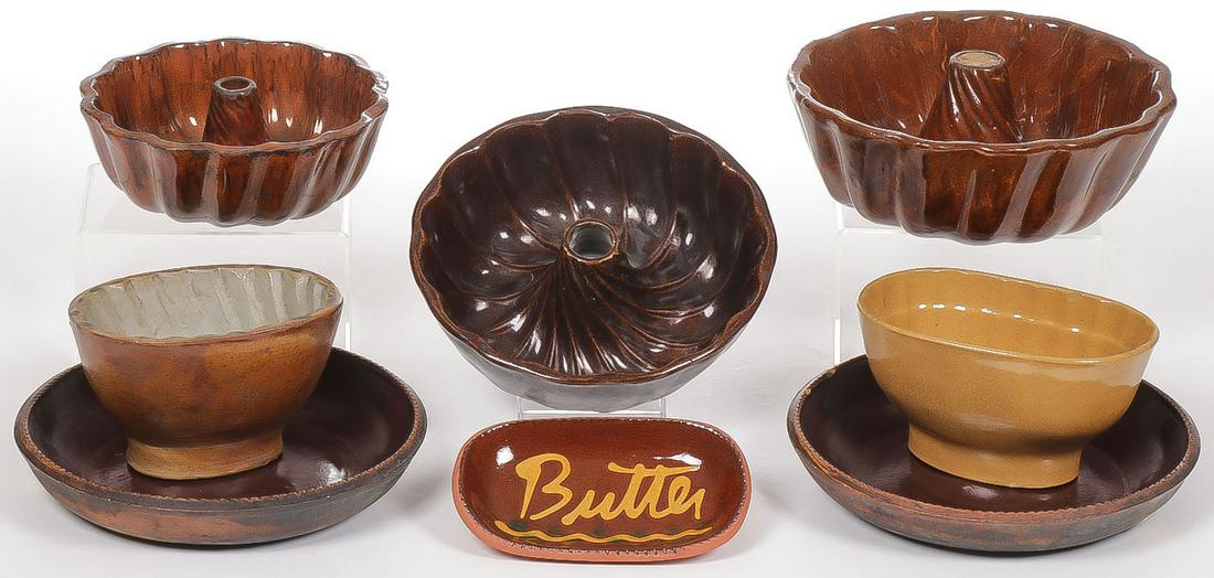 VINTAGE REDWARE FOOD MOLDS: VINTAGE REDWARE FOOD MOLDS. Comprising five redware and yellow ware food molds, two redware plates with brown glaze and a slip decorated butter dish. Greatest diameter 9 inches.SHIPPING NOTICE:Jacks