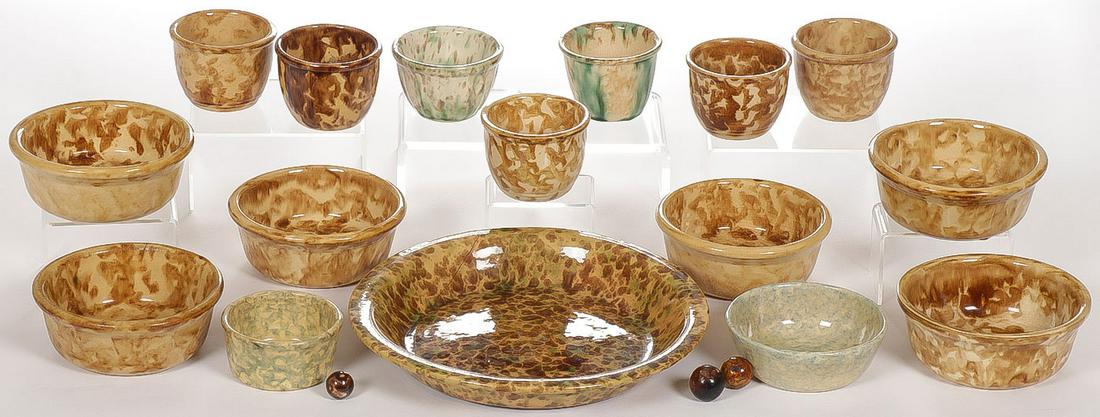 YELLOW WARE SPONGE DECORATED GROUP: YELLOW WARE SPONGE DECORATED GROUP. Comprising 16 individual pieces, including bowls, cups and plate in spatter or sponge decorated glaze, together with three Bennington glazed marbles. Greatest diam