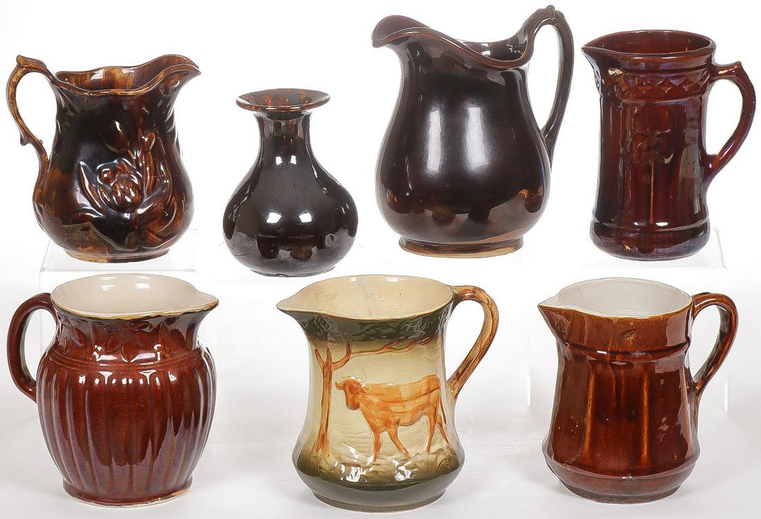 CREAM WARE PITCHERS: CREAM WARE PITCHERS. Comprising six cream ware pitchers, five with Bennington glazes and a Bennington vase with flared mouth. Greatest height 9.5 inches. SHIPPING NOTICE: Jackson's is your sole