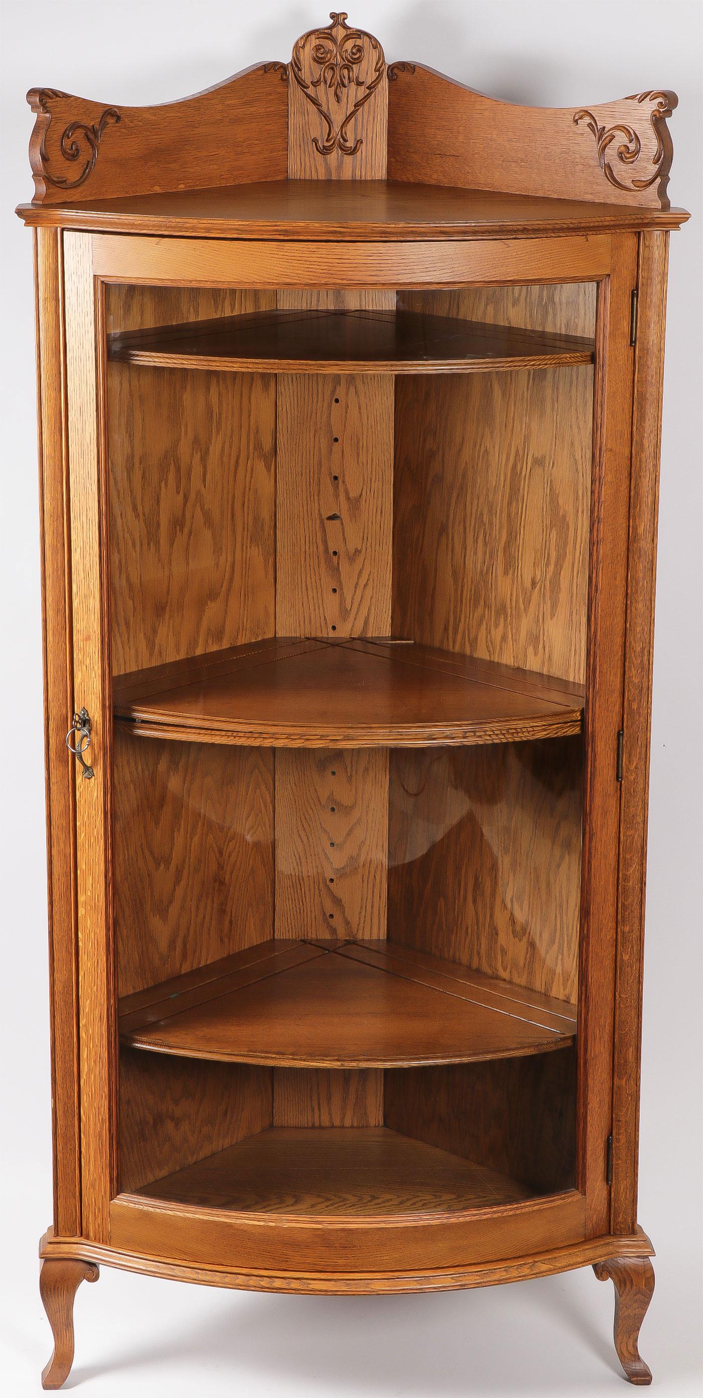 OAK CORNER CURVED CHINA: OAK CORNER CURVED CHINA. In excellent condiition with three adjustable shelves and ornate gallery. Height 67 inches, width 31 inches. SHIPPING NOTICE: Jackson's is your sole and only source for o