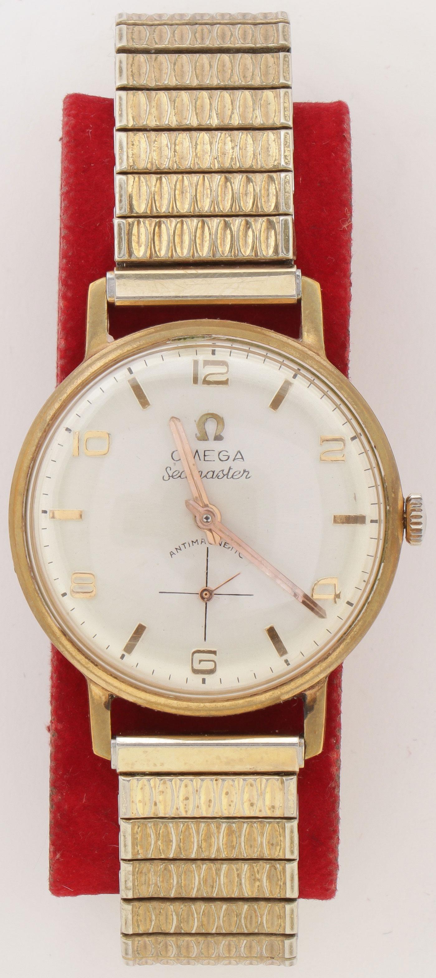 OMEGA SEAMASTER STYLE ANTIMAGNETIC WRISTWATCH: AN OMEGA SEAMASTER STYLE ANTIMAGNETIC WRISTWATCH. With Omega style box, takes a wind and seems to run, and although marked 18K the case is not gold and we believe the watch is an imitation. SHIPPING N