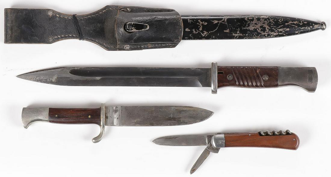 THREE GERMAN WWII EDGED WEAPONS: THREE GERMAN WWII EDGED WEAPONS. Comprising a German WWII K98 bayonet with bakelite grips, black painted metal scabbard (not matching numbers) and leather frog maker's marked GFG and dated 1943. T
