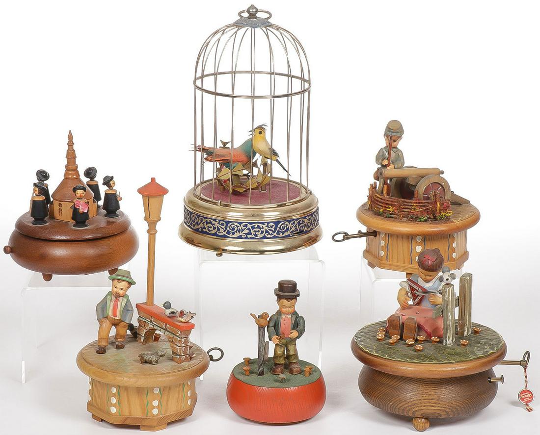 ANRI MUSIC BOXES & SINGING BIRD CAGE: ANRI MUSIC BOXES & SINGING BIRD CAGE. Comprising four Anri painted wood figural music boxes and a Reuge Swiss wood music box. As well as a mechanical singing bird cage. Greatest height 11 inches. SHIP