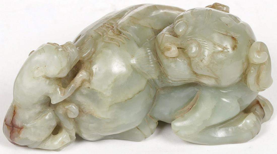 CHINESE CARVED JADE LION & CUB, QING: CHINESE CARVED JADE LION & CUB, QING. The large recumbent beast carved in the round with a young cub resting on its back. Length 4 inches (10cm). SHIPPING NOTICE: Jackson's is your sole and only s