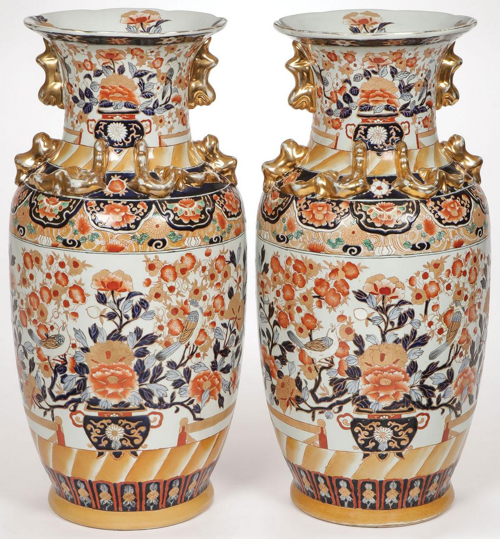PR OF AMARI DECORATED PORCELAIN VASES: PR OF AMARI DECORATED PORCELAIN VASES. Comprising a matching pair of heavily decorated vases with scalloped rims and raised gilt decorative elements on shoulder and neck. Underside of base with five&#
