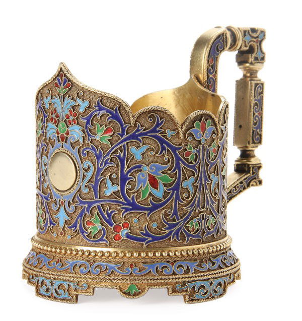 RUSSIAN SILVER AND ENAMEL TEA GLASS HOLDER: A FINE RUSSIAN SILVER-GILT AND CLOISONNE ENAMELED TEA GLASS HOLDER, GRACHEV, ST. PETERSBURG, 1890. Resting on bracketed feet with beaded border, the cylindrical body with scalloped rim enameled with s