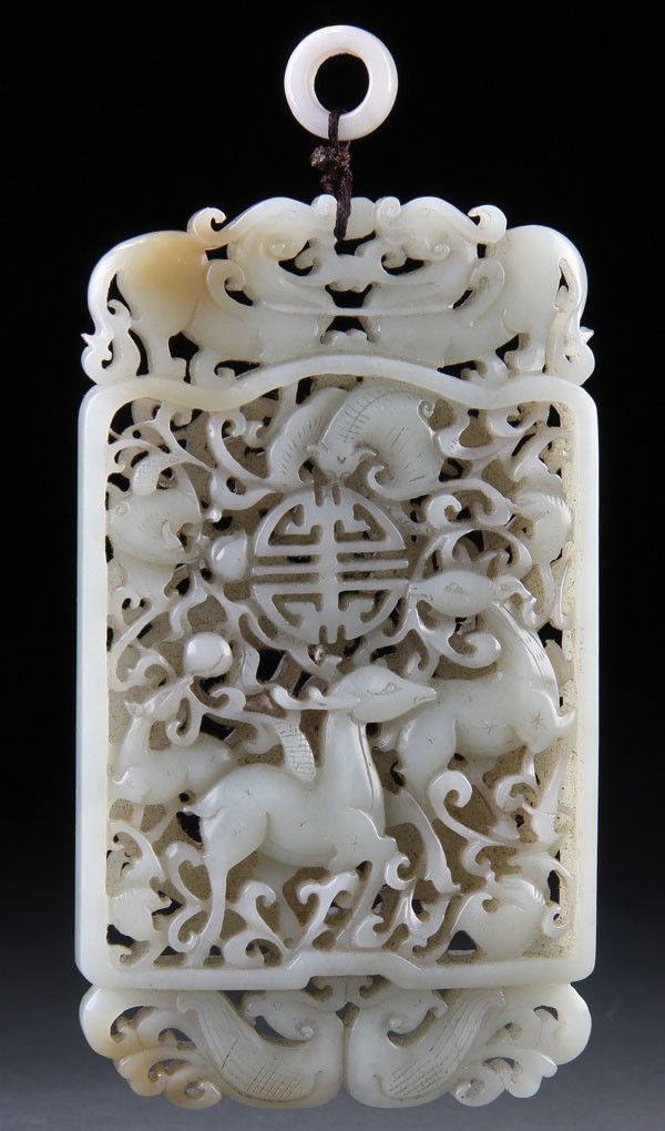 A CHINESE CARVED WHITE JADE ORNAMENTAL PLAQUE: A VERY FINE CHINESE CARVED WHITE JADE ORNAMENTAL PENDANT PLAQUE, LATE QING/EARLY REPUBLIC PERIOD. In a fine even toned white jade with light russet highlight, well carved and polished with an open wor