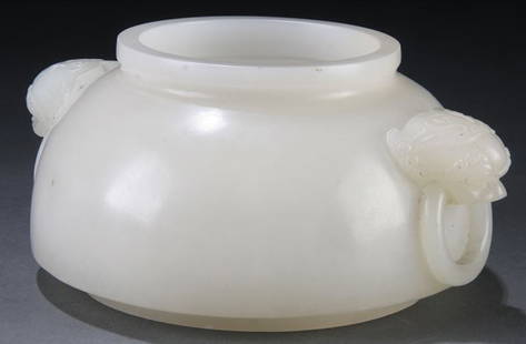 A GOOD CHINESE CARVED WHITE JADE BRUSH WASHER: A GOOD CHINESE CARVED WHITE JADE BRUSH WASHER. The diminutive "purse form" handled brush washer with mythical beast head handles and attached suspended rings carved in an even-toned white jade with a