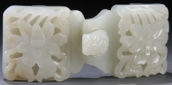 A GOOD CHINESE CARVED WHITE JADE BELT BUCKLE: A GOOD CHINESE CARVED WHITE JADE TWO-PIECE BELT BUCKLE, LATE QING/EARLY REPUBLIC PERIOD. In even toned pale celadon colored white jade, carved with an openwork design of rosettes and branches with a d