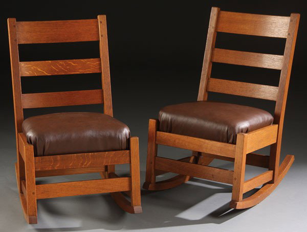 2 L & J.G. STICKLEY ARTS AND CRAFTS OAK ROCKERS: A PAIR OF L & J.G. STICKLEY ARTS AND CRAFTS OAK SEWING ROCKERS, EARLY 20TH CENTURY. With three horizontal slat backs and later leather upholstered cushions. Height 31 inches (79 cm), width 17 inches (