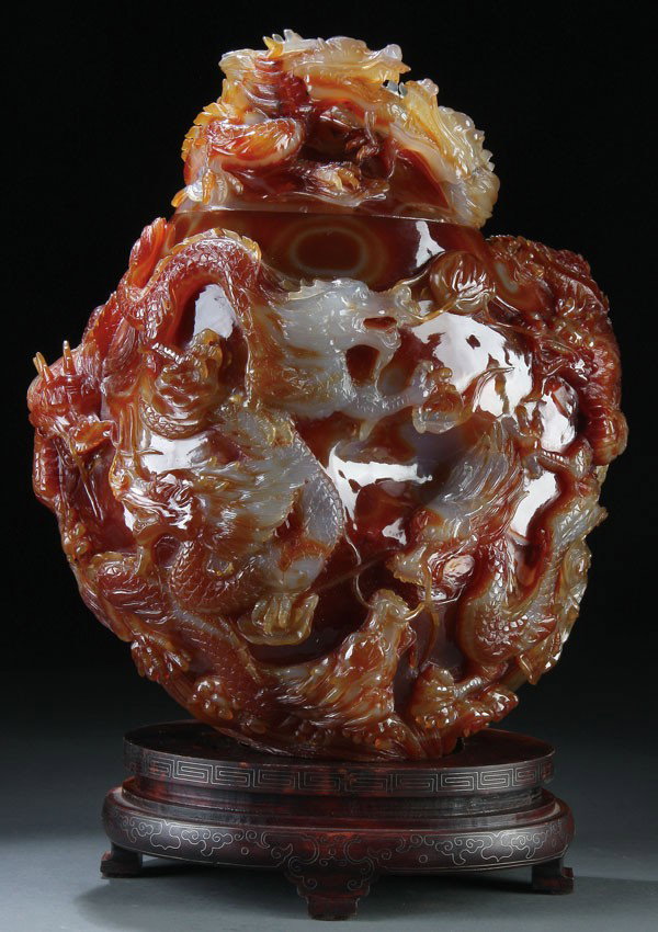 CHINESE DRAGON CARVED CARNELIAN AGATE VASE: A MONUMENTAL CHINESE DRAGON CARVED CARNELIAN AGATE PALACE-SIZED COVERED VASE, 20TH CENTURY. The carnelian boulder in deep amber and milky pale grey/white with orange bands expertly carved and polished