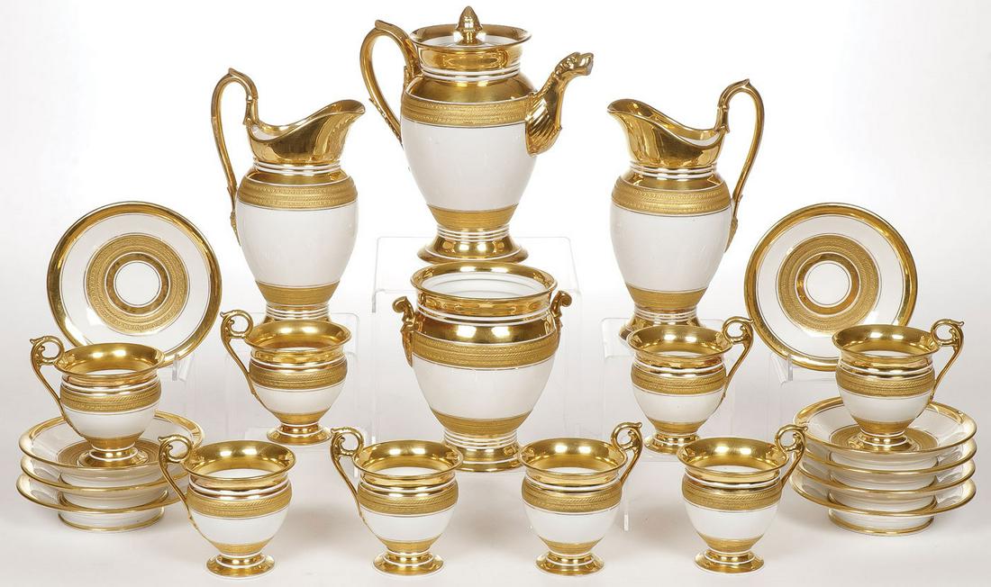 IMPRESSIVE PORCELAIN TEA SERVICE, LIKELY RUSSIAN: AN IMPRESSIVE PORCELAIN TEA SERVICE, LIKELY RUSSIAN, C. 1830. Comprising a 21- piece porcelain tea service. Each piece with ornate burnished gilding and with incised gilt banding. Consisting of a lidd