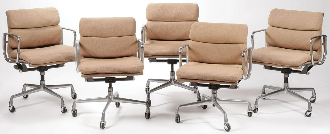 CHARLES EAMES/HERMAN MILLER SOFT PAD ARM CHAIRS: CHARLES EAMES/HERMAN MILLER SOFT PAD ARM CHAIRS. Comprising five Eames for Herman Miller low back Soft pad rolling office chairs, upholstered in tan fabric, underside of each with original manufacture