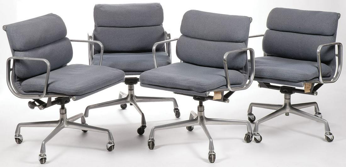 CHARLES EAMES/HERMAN MILLER SOFT PAD ARM CHAIRS: CHARLES EAMES/HERMAN MILLER SOFT PAD ARM CHAIRS. Comprising four circa 1985 low back Soft pad rolling office chair by Charles Eames for Herman Miller, upholstered in blue fabric, each with original ma