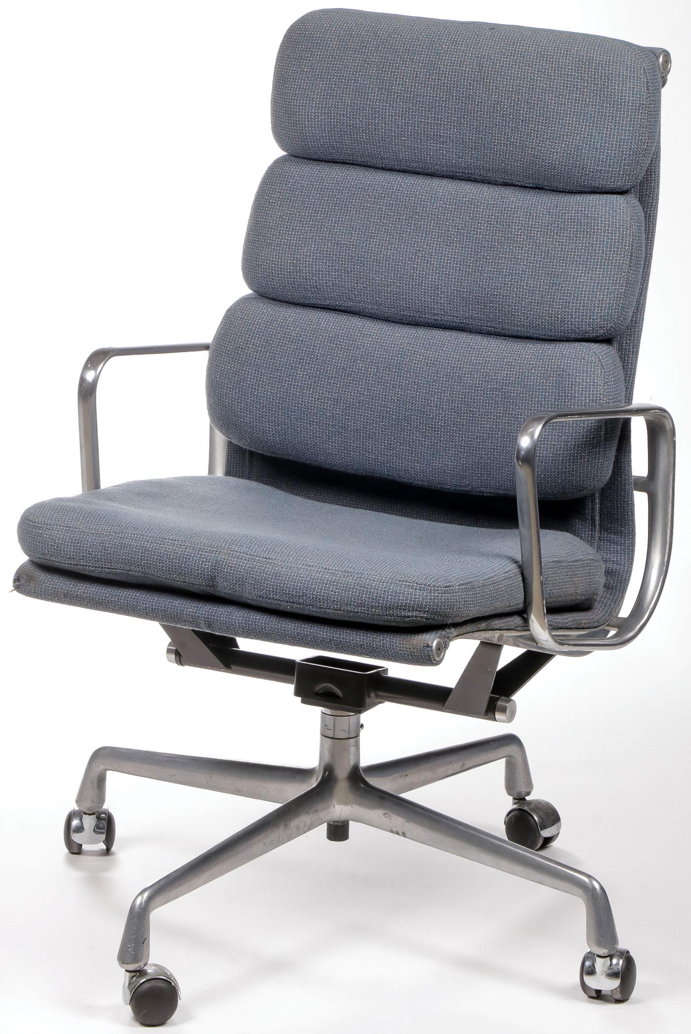 EAMES/HERMAN MILLER EXECUTIVE ARM CHAIR: EAMES/HERMAN MILLER EXECUTIVE ARM CHAIR. Comprising an executive height soft pad rolling arm chair by Charles Eames for Herman Miller, upholstered in blue fabric, with original manufacturer's label an