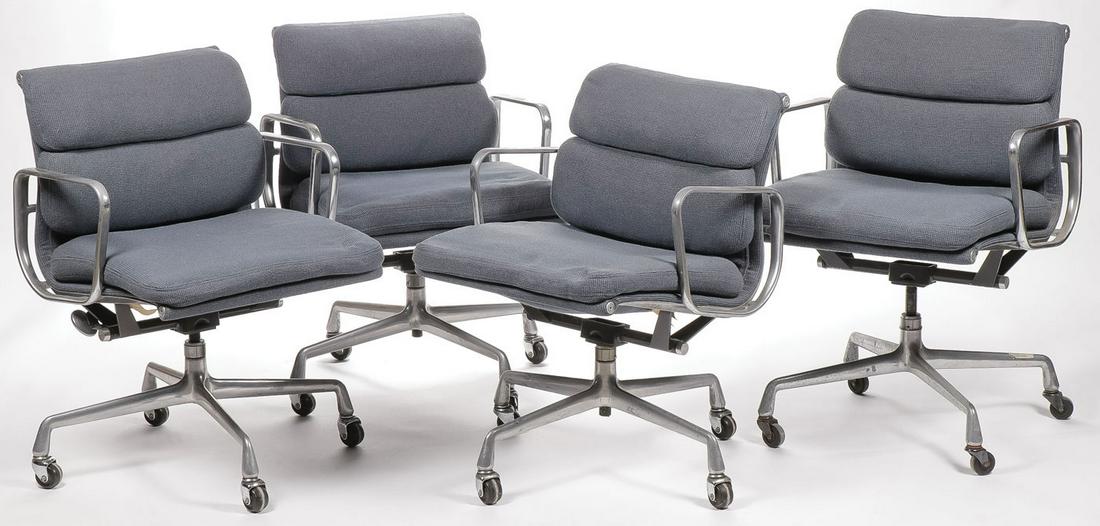 CHARLES EAMES/HERMAN MILLER SOFT PAD ARM CHAIRS: CHARLES EAMES/HERMAN MILLER SOFT PAD ARM CHAIRS. Comprising four circa 1985 low back Soft pad rolling office chair by Charles Eames for Herman Miller, upholstered in blue fabric, each with original ma