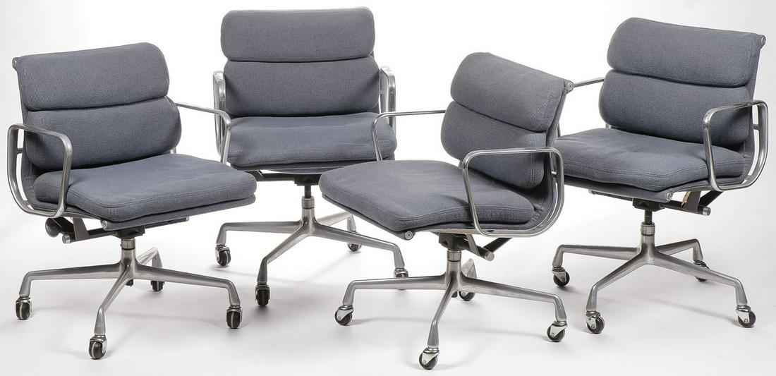CHARLES EAMES/HERMAN MILLER SOFT PAD ARM CHAIRS: CHARLES EAMES/HERMAN MILLER SOFT PAD ARM CHAIRS. Comprising four circa 1985 low back Soft pad rolling office chair by Charles Eames for Herman Miller, upholstered in blue fabric, each with original ma