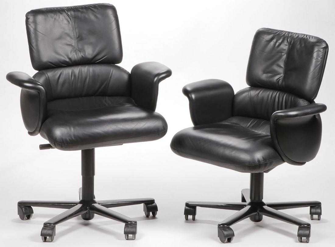 GEOFF HOLLINGTON HERMAN MILLER LOUNGE CHAIRS: GEOFF HOLLINGTON HERMAN MILLER LOUNGE CHAIRS. Comprising two low back desk chairs upholstered in black leather, height 40 inches, width 30 inches, depth 19 inches. SHIPPING NOTICE: Jackson's is your s