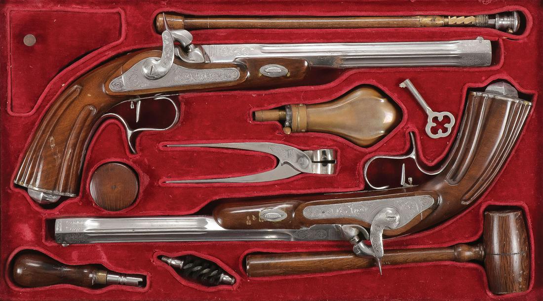 PAIR OF ATTRACTIVE CASED DUELING PISTOLS: PAIR OF ATTRACTIVE CASED DUELING PISTOLS. Comprising a matched set of finely finished percussion dueling pistols in the French or Belgian 19th century style. With fluted and engraved barrels and locks