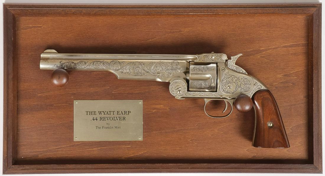 REPLICA WYATT EARP .44 REVOLVER: REPLICA WYATT EARP .44 REVOLVER. Comprising a Franklin Mint Wyatt Earp engraved replica revolver on mounted wall plaque. Serial number 20029 SHIPPING NOTICE: Jackson's is your sole and only source for