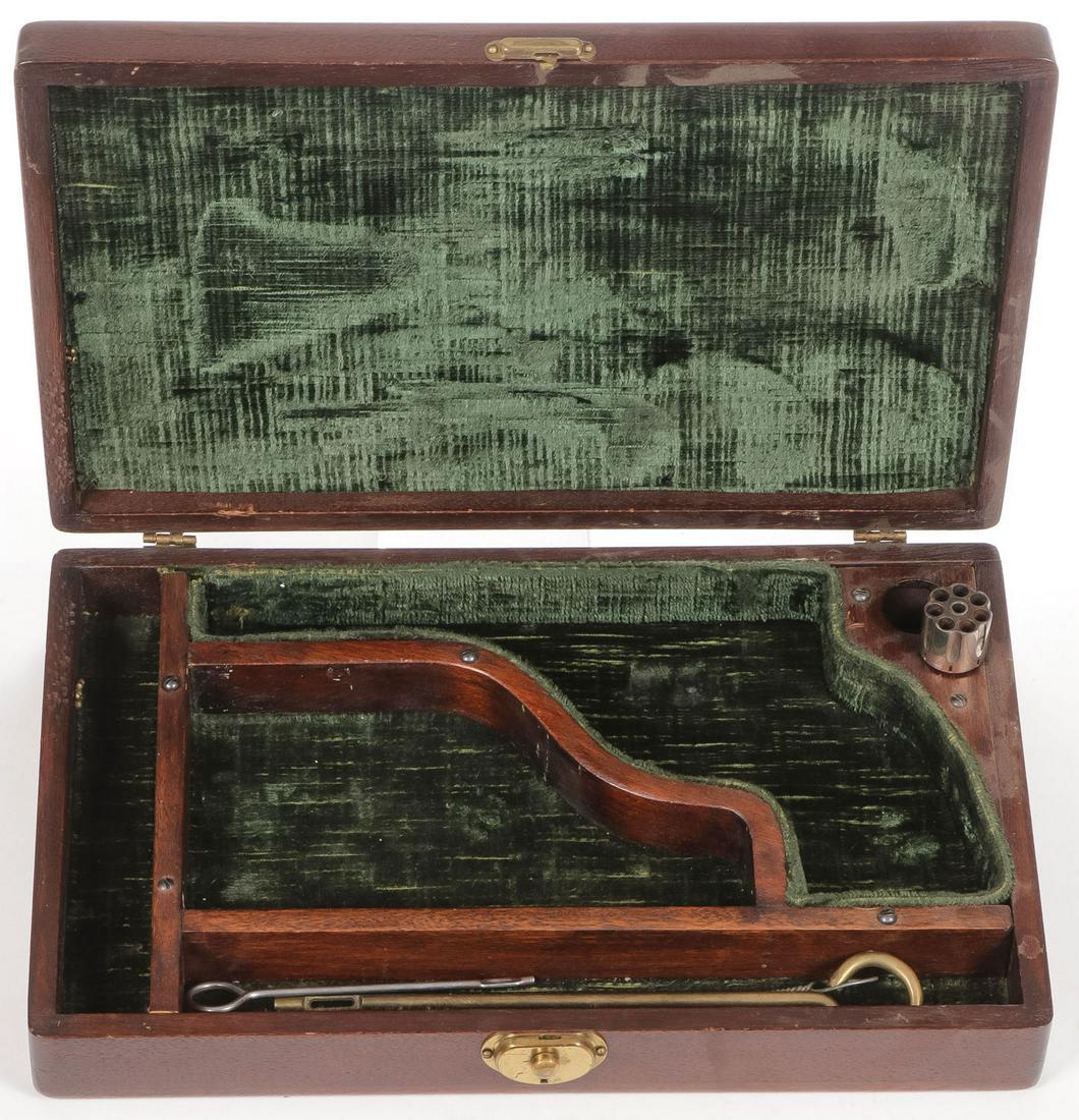 A GOOD MAHOGANY PISTOL CASE: A GOOD MAHOGANY PISTOL CASE. The interior divided into various compartments and lined in velvet, includes a seven shot nickel-plated cylinder, .22 caliber, as well as cleaning rods, 13.5 inches x 8.5 