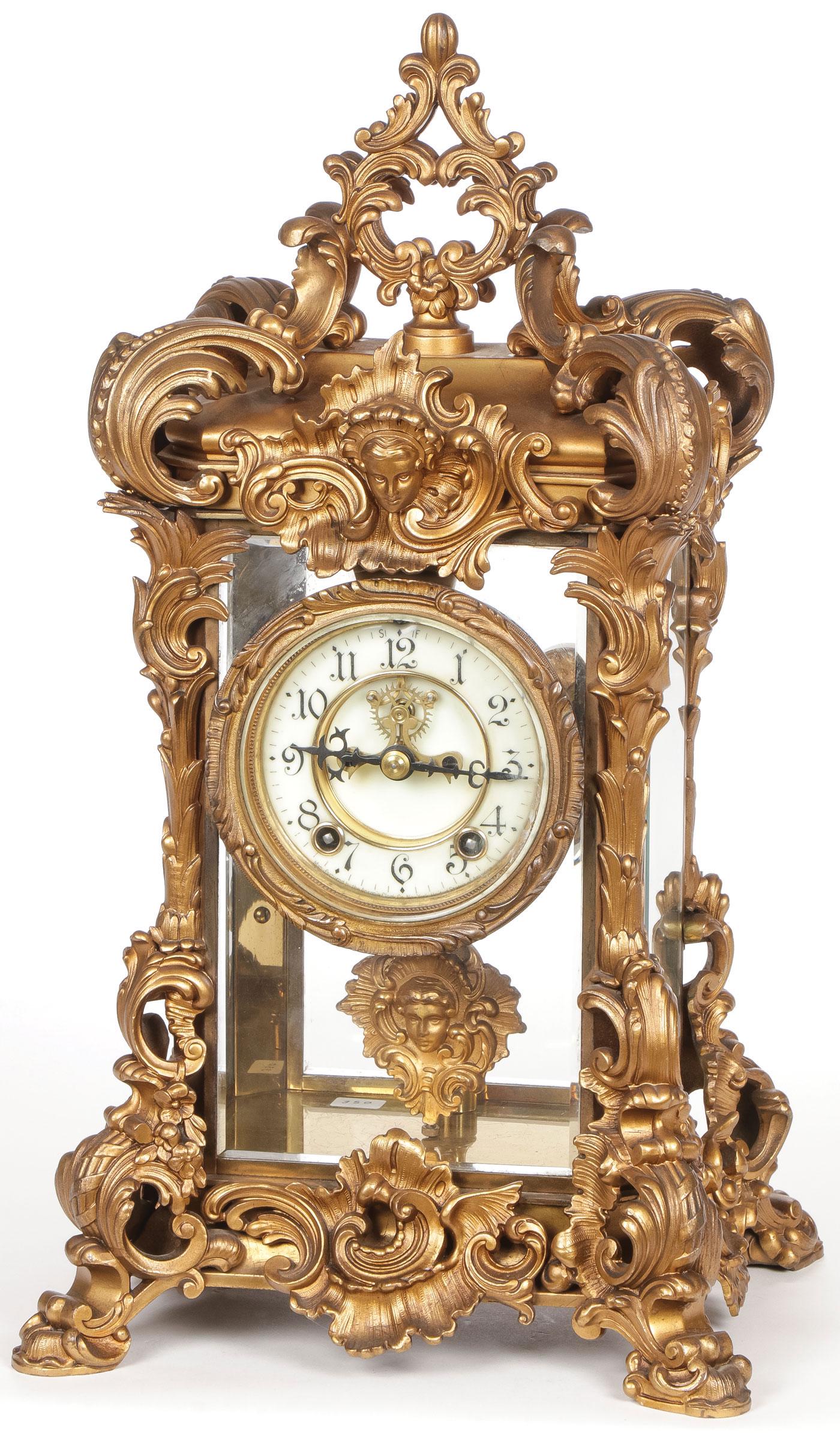 ANSONIO BRASS & GLASS MANTEL CLOCK: ANSONIO BRASS & GLASS MANTEL CLOCK. The ornate case with beveled glass sides and Arabic numerals on dial, height 18.5 inches. SHIPPING NOTICE: Jackson's is your sole and only source for one stop packi