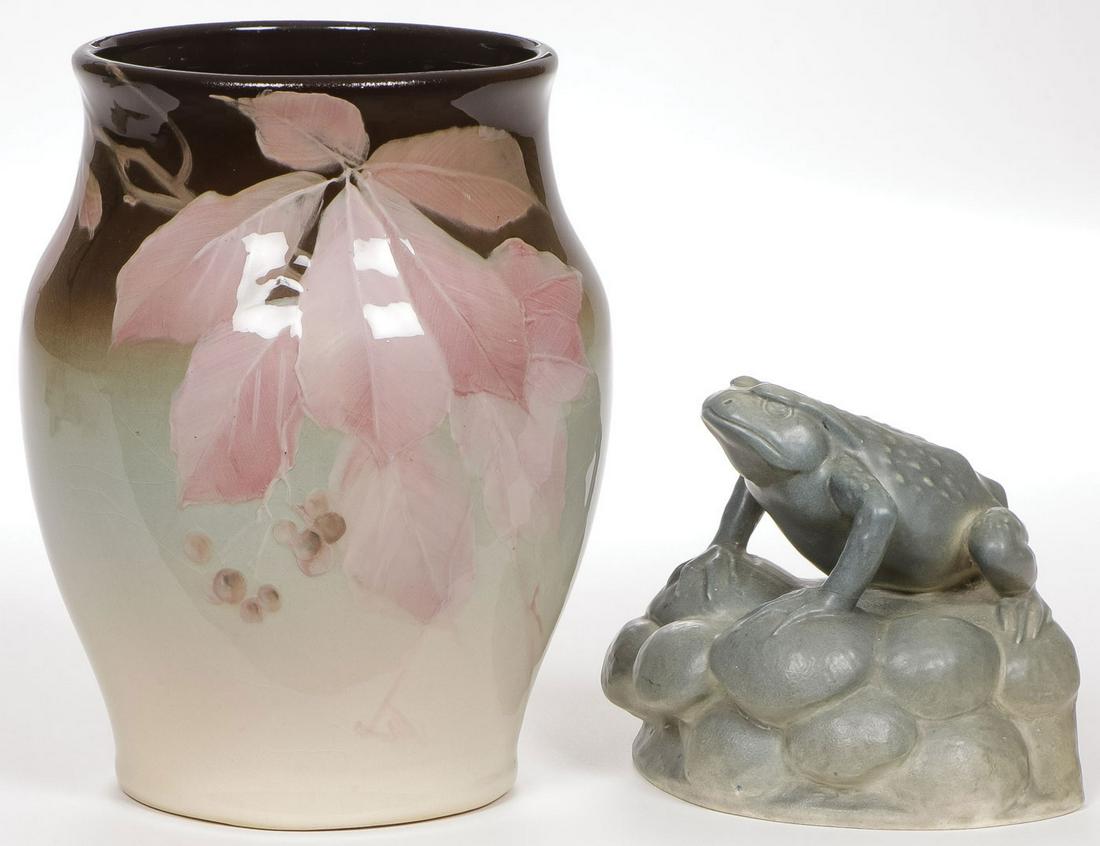 ROOKWOOD AND WELLER POTTERY GROUP: ROOKWOOD AND WELLER POTTERY GROUP. Comprising a poinsettia decorated Weller Eocean vase with impressed mak, height 8.5 inches, together with an attractive Rookwood frog book end dated 1922, height 5 i