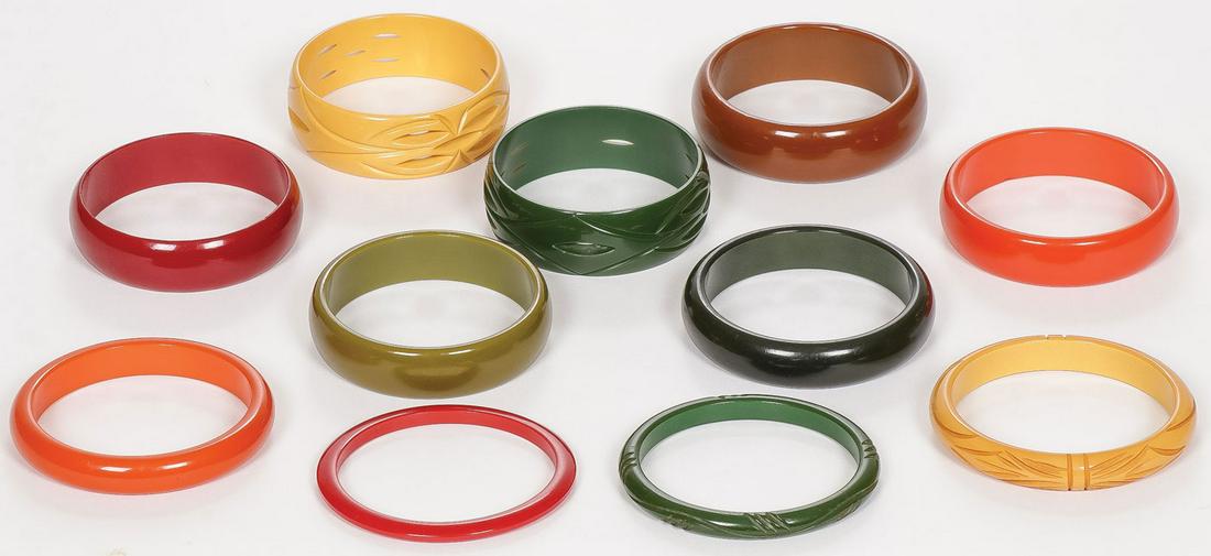 11 BAKELITE BANGLE BRACELETS: 11 BAKELITE BANGLE BRACELETS. Four with carved decoration, the others solid.SHIPPING NOTICE:Jackson's is your sole and only source for one stop packing and shipping. With over 50 years of experience