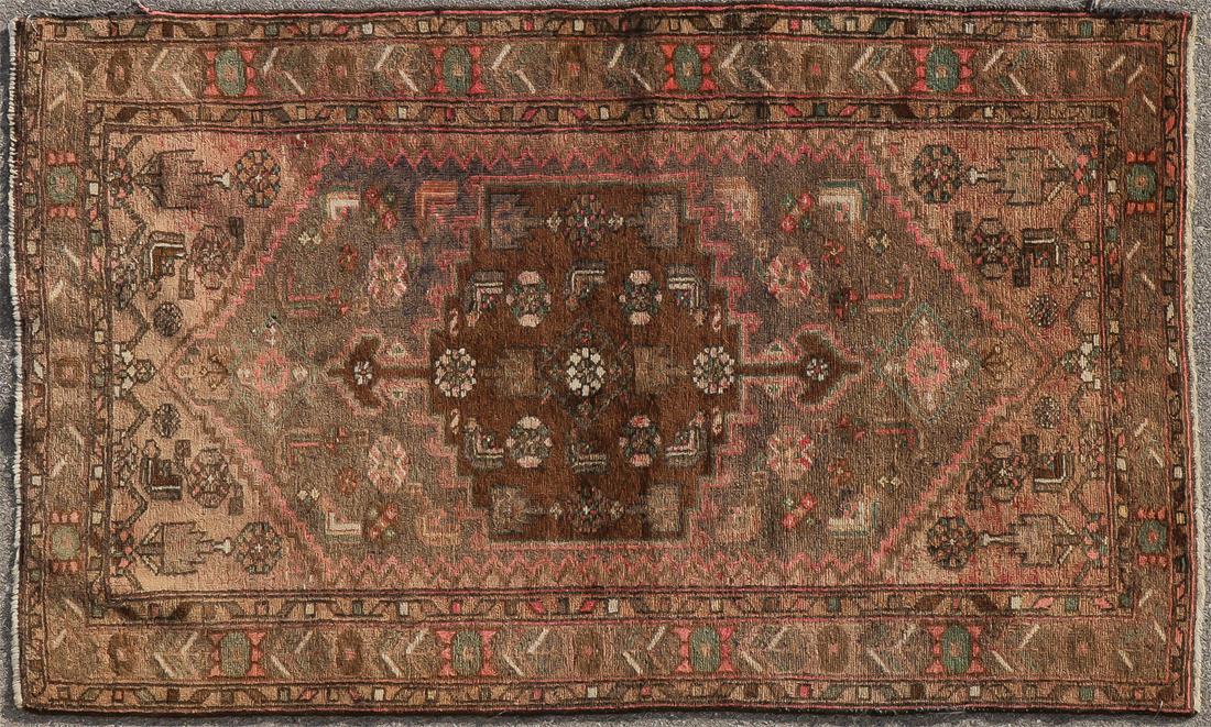AN ORIENTAL CARPET: AN ORIENTAL CARPET. Comprising a border with floral pattern with diamond and floral design at center. 84 inches x 48 inches. SHIPPING NOTICE: Jackson's is your sole and only source for one stop packin