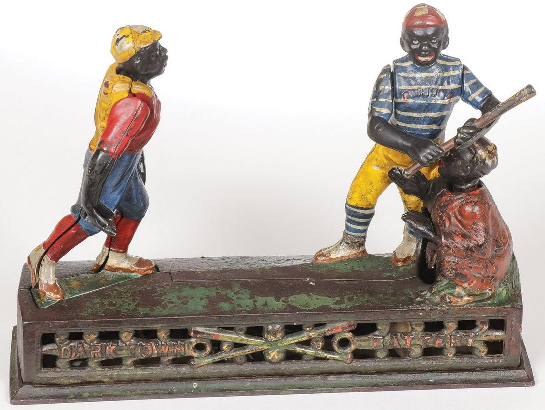 DARKTOWN BATTERY MECHANICAL BANK: DARKTOWN BATTERY MECHANICAL BANK. Comprising a J & E Stevens cast iron mechanical bank in original paint in good working condition. 10 inches x 2.75 inches x 7 inches. SHIPPING NOTICE: Jackson's is yo