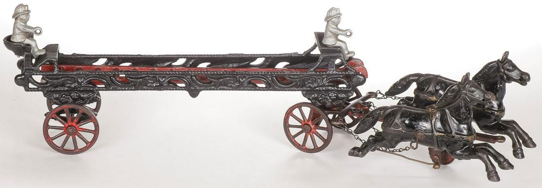 CAST IRON FIRE LADDER WAGON: CAST IRON FIRE LADDER WAGON. With two horse teams, two drivers and ladder. Apparently unmarked. Length 20 inches. SHIPPING NOTICE: Jackson's is your sole and only source for one stop packing and shipp