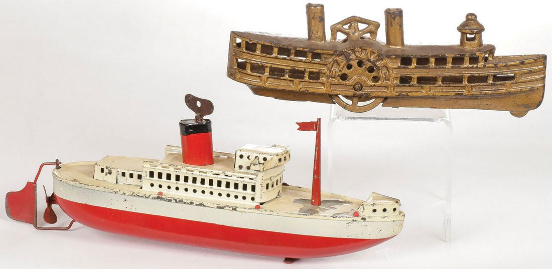 VINTAGE PADDLE WHEEL AND STEAM SHIP: VINTAGE PADDLE WHEEL AND STEAM SHIP. Comprising a cast iron arcade paddle wheel remnant of original label together with a painted tin key wind steam ship. Each in original paint. Greatest length 10 in