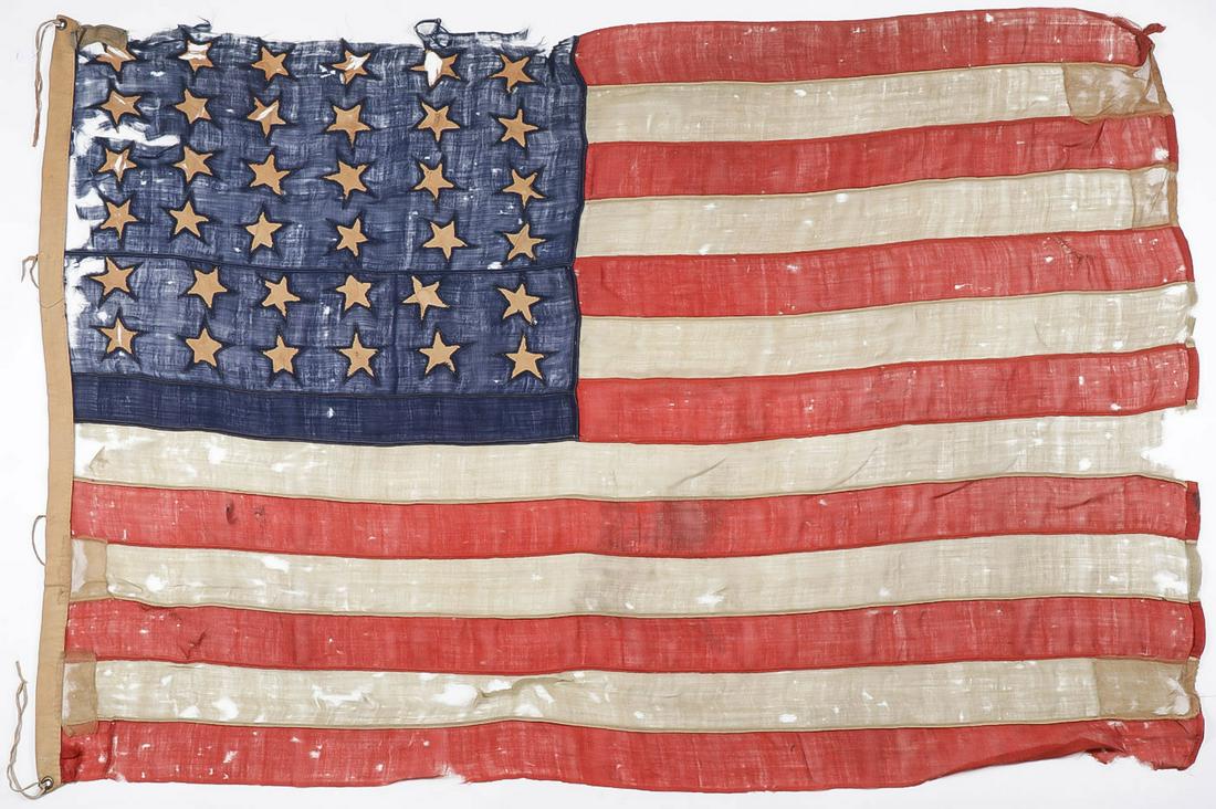 LARGE CIVIL WAR PERIOD 36 STAR AMERICAN FLAG: LARGE CIVIL WAR PERIOD 36 STAR AMERICAN FLAG. Comprising a Civil War Period Thirty-Six Star American Flag, (1865-1867). Treadle and hand sewn multi piece wool construction with hand cut and hand sewn 