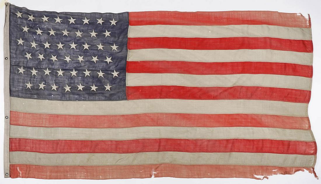 LARGE SPANISH AMERICAN WAR PERIOD 45 STAR US FLAG: LARGE SPANISH AMERICAN WAR PERIOD 45 STAR US FLAG. Comprising a large and impressive wool 45-star US flag (1896-1908) with canvas hoist set with four brass gromets. 51 inches x 90 inches. SHIPPING NOT