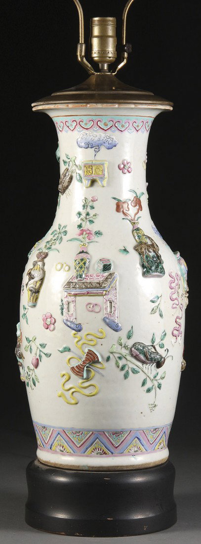 CHINESE PORCELAIN HAND-PAINTED FLOOR VASE: A LARGE AND IMPRESSIVE CHINESE PORCELAIN HAND-PAINTED AND EMBOSSED FLOOR VASE, 19TH/20TH CENTURY. The exterior displaying large embossed Buddhist symbols heightened in polychrome enamels, later lamp c