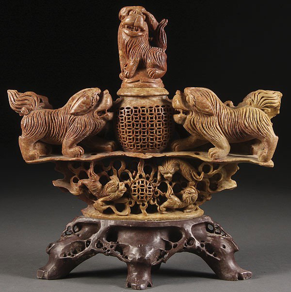 A CHINESE CARVED SOAPSTONE FIGURAL CENSER: A CHINESE CARVED SOAPSTONE FIGURAL CENSER, 20TH CENTURY. Carved with figural foo dogs raised on an open work pedestal. Length 12 inches (30.5 cm).