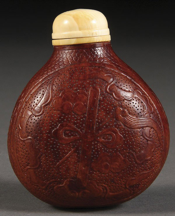 A CHINESE CARVED GOURD AND IVORY SNUFF BOTTLE: A FINE CHINESE CARVED GOURD AND IVORY MOUNTED SNUFF BOTTLE, EARLY 20TH CENTURY. Well carved with Buddhist symbols on a stippled ground with seal mark on base. Height 2.5 inches (6.5 cm).NOTICE TO BIDD