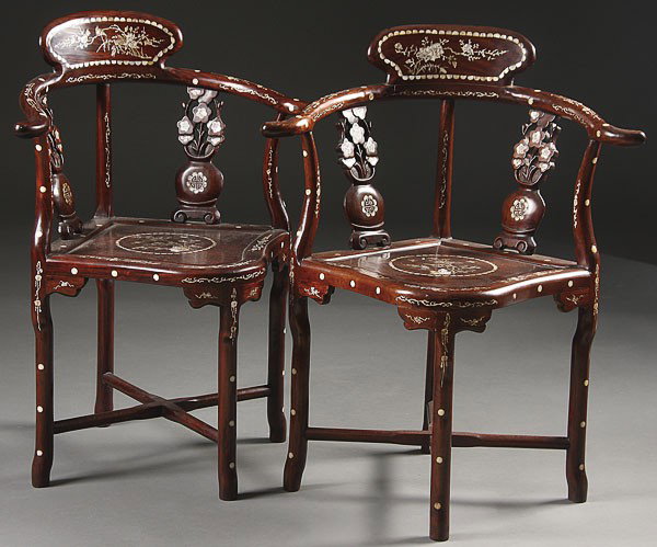 CHINESE CARVED HARDWOOD AND MOTHER OF PEARL CHAIRS: A PAIR OF CHINESE CARVED HARDWOOD AND MOTHER OF PEARL INLAID ARM CHAIRS, each with bird and floral designs on back with Buddhist symbols, height 33 inches, width 26 inches, depth 21 inches.NOTICE TO B