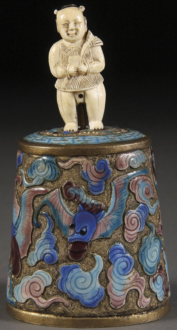 A CHINESE ENAMELED BRONZE AND CARVED IVORY BELL: A CHINESE ENAMELED BRONZE AND CARVED IVORY BELL, 19TH/20TH CENTURY. The tapering cylindrical bell embossed and enameled with four bats in clouds below a figural carved ivory handle. Height 4.75 inches