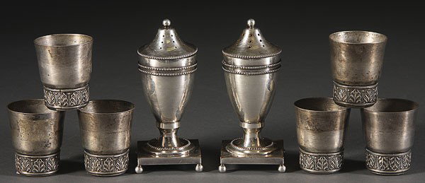 POLISH SILVER SHOT GLASSES & GEORGE III SHAKERS: A SET OF SIX POLISH SILVER SHOT GLASSES, EARLY 20TH CENTURY. With embossed leaf and dart border and stamped hallmarks for 800 silver, together with a pair of English Sheffield plate George III salt an