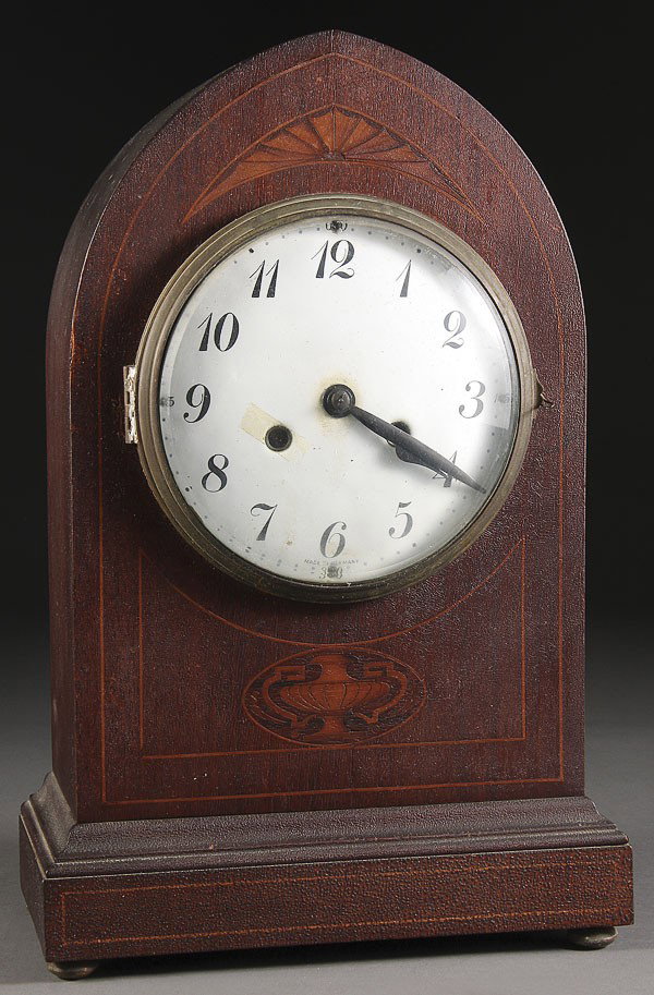 A GERMAN SHELF CLOCK, EARLY 20TH CENTURY: A GERMAN SHELF CLOCK, EARLY 20TH CENTURY. In a marquetry inlaid mahogany case. Height 17.5 inches.