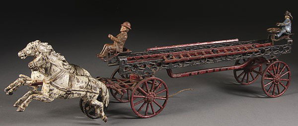 A VINTAGE TOY CARPENTER CAST IRON HOOK AND LADDER: A VINTAGE CARPENTER CAST IRON TOY HOOK AND LADDER HORSE AND FIRE WAGON, LATE 19TH CENTURY, with two horse team figures and ladder. Length 26.5 inches