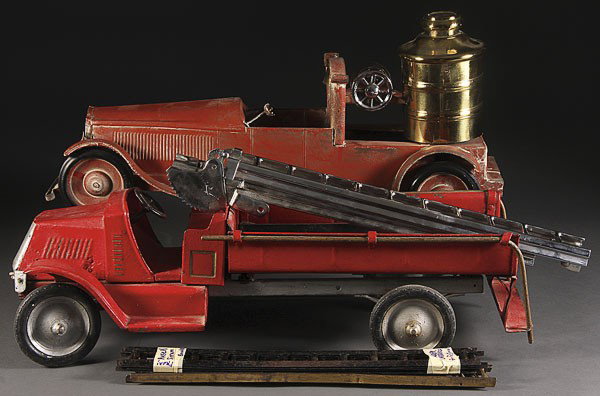 EARLY PRESSED STEEL TOY FIRE TRUCKS: A PAIR OF EARLY PRESSED STEEL TOY FIRE TRUCKS, CIRCA 1920'S, including a steel craft ladder truck with added nickel plate ladder, and a Turner Toy with added brass water tank, early repaint, length 27