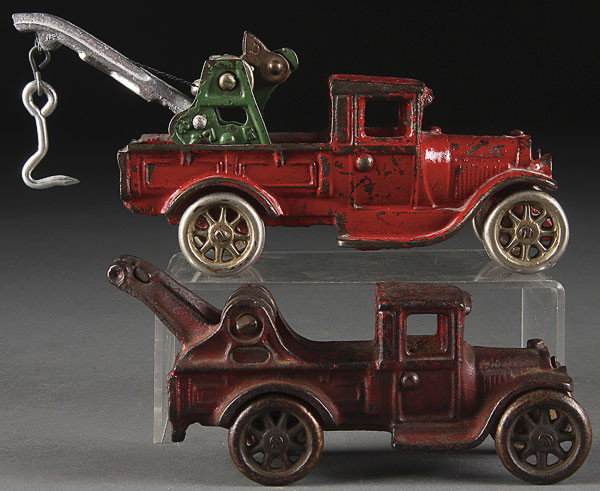 A PAIR OF ARCADE CAST IRON TOY WRECKERS: A PAIR OF ARCADE CAST IRON TOY WRECKERS, EARLY 20TH CENTURY, one with replaced hoist boom. Length 6 inches and 7 inches.