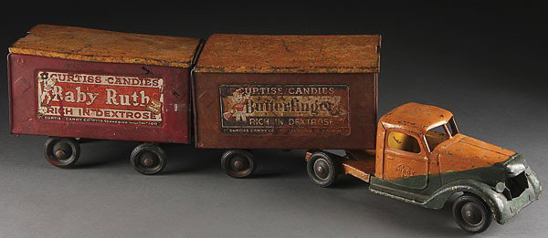 BUDDY L TOY BABY RUTH/BUTTERFINGER CAB & TANDEM: A BUDDY L TOY BABY RUTH/BUTTERFINGER CAB AND TANDEM TRAILER, CIRCA 1930'S, some early over paint and missing grill. Length 36 inches.