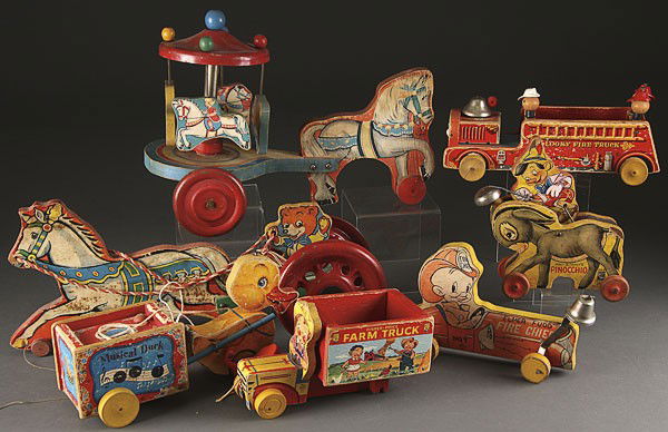 EARLY FISHER PRICE, BRICE & HILL WOODEN PULL TOYS: AN EARLY FISHER PRICE, BRICE & HILL WOODEN PULL TOY COLLECTION. Eight pieces including Pinocchio, Elmer Fudd, Bugs Bunny, and others, all with losses. The largest 19 inches.