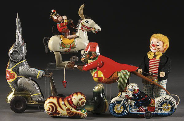 SIX JAPANESE TIN LITHO WIND UP AND FRICTION TOYS: SIX JAPANESE TIN LITHO WIND UP AND FRICTION TOYS. Including a circuit elephant, monkey on horse, motorcycle, drummer clown, and climbing monkey, together with a West German Lehmann seal. The largest 8