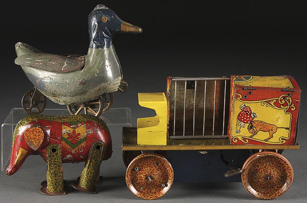 A LINDSTROM TIN LITHO CIRCUS WAGON ELEPHANT: A LINDSTROM TIN LITHO CIRCUS WAGON AND WIND UP ELEPHANT together with a 19th century pressed steel duck hill climber, length 6 inches to 10 inches.