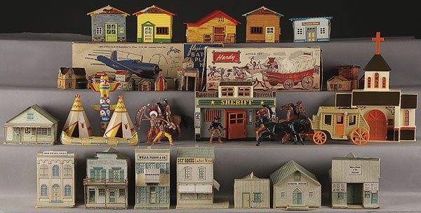 A LARGE WESTERN TOY TOWN COLLECTION, MID 20TH CENT: A LARGE WESTERN TOY TOWN COLLECTION, MID 20TH CENTURY, including paper lithographed buildings, die cut buildings, a Hardy plastic covered wagon, and later plastic Western theme buildings and accessori